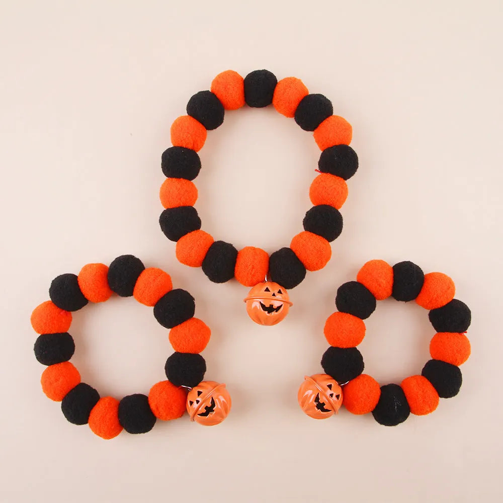 Orange and black Halloween cat collar with pumpkin design and plastic quick-release buckle.
