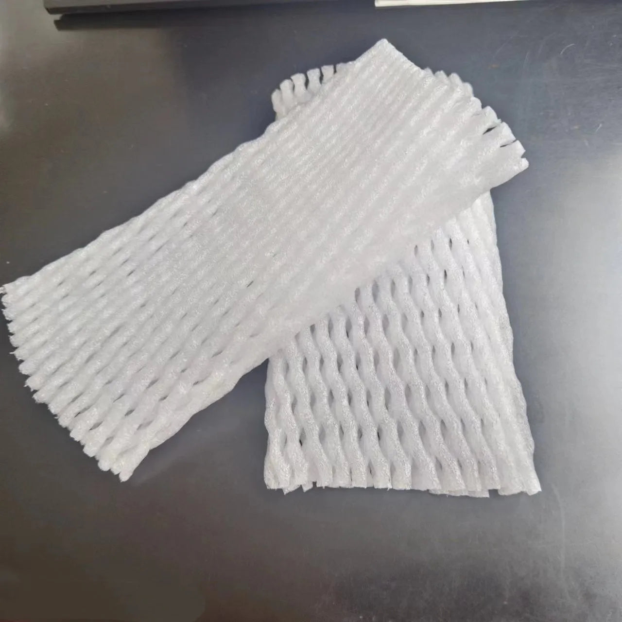 White foam protective net cover for apples, pears, peaches and oranges.