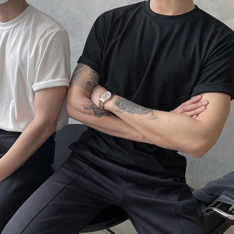 Slim fit men's cotton T-shirt in black on a white background, showing round neck and short sleeves.