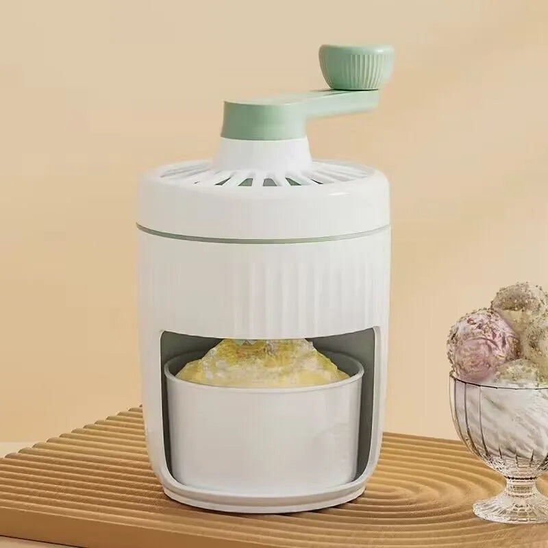 Hand-cranked ice shaving machine in green and orange, compact portable snow cone maker with ergonomic handle and removable ice box.