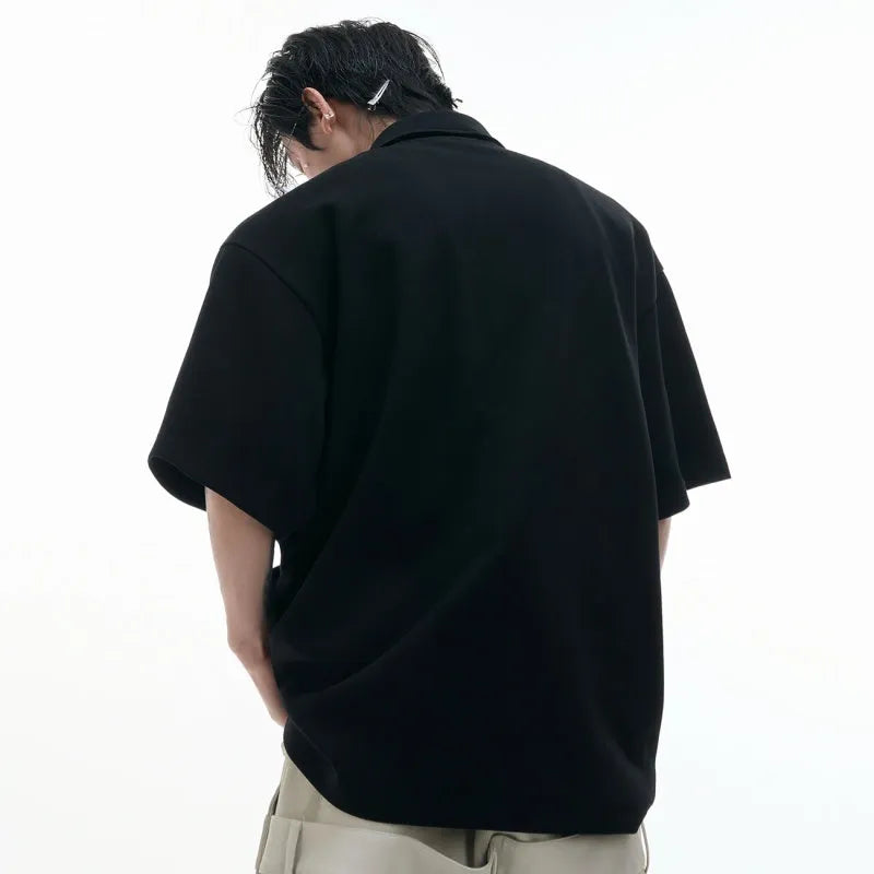 Men's loose deconstructed collar polo shirt with geometric pattern in black.