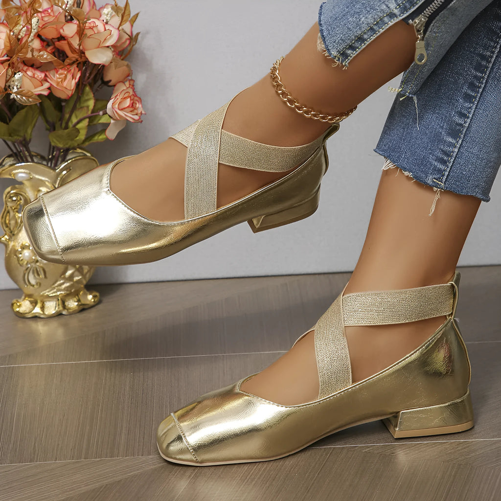 Gold slip-on square toe evening pumps with a low heel on a white background.
