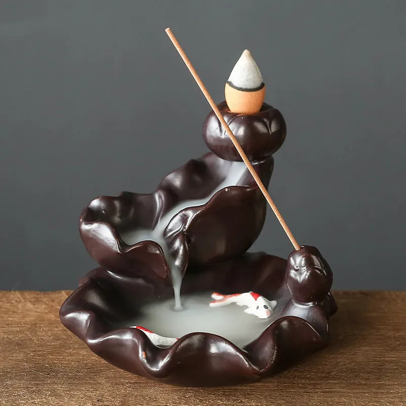 Ceramic backflow incense burner ornament in modern tree design on a table.