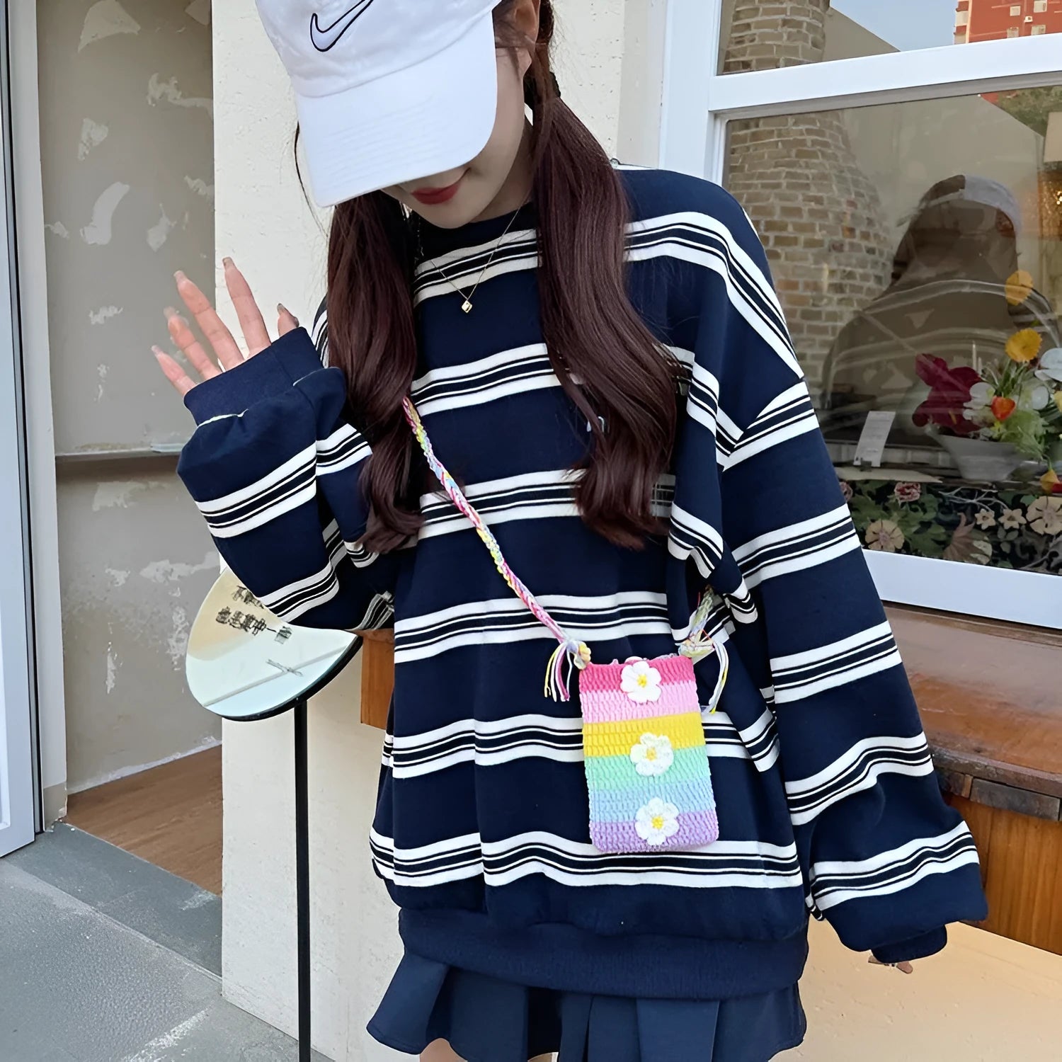 Colourful plush mobile phone shoulder bag with red and pink flower pendant decoration.