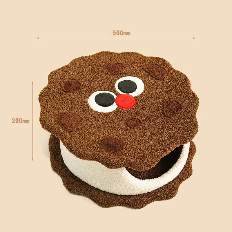 Khaki coloured enclosed cat nest shaped like a sandwich cookie for cold weather sleeping.
