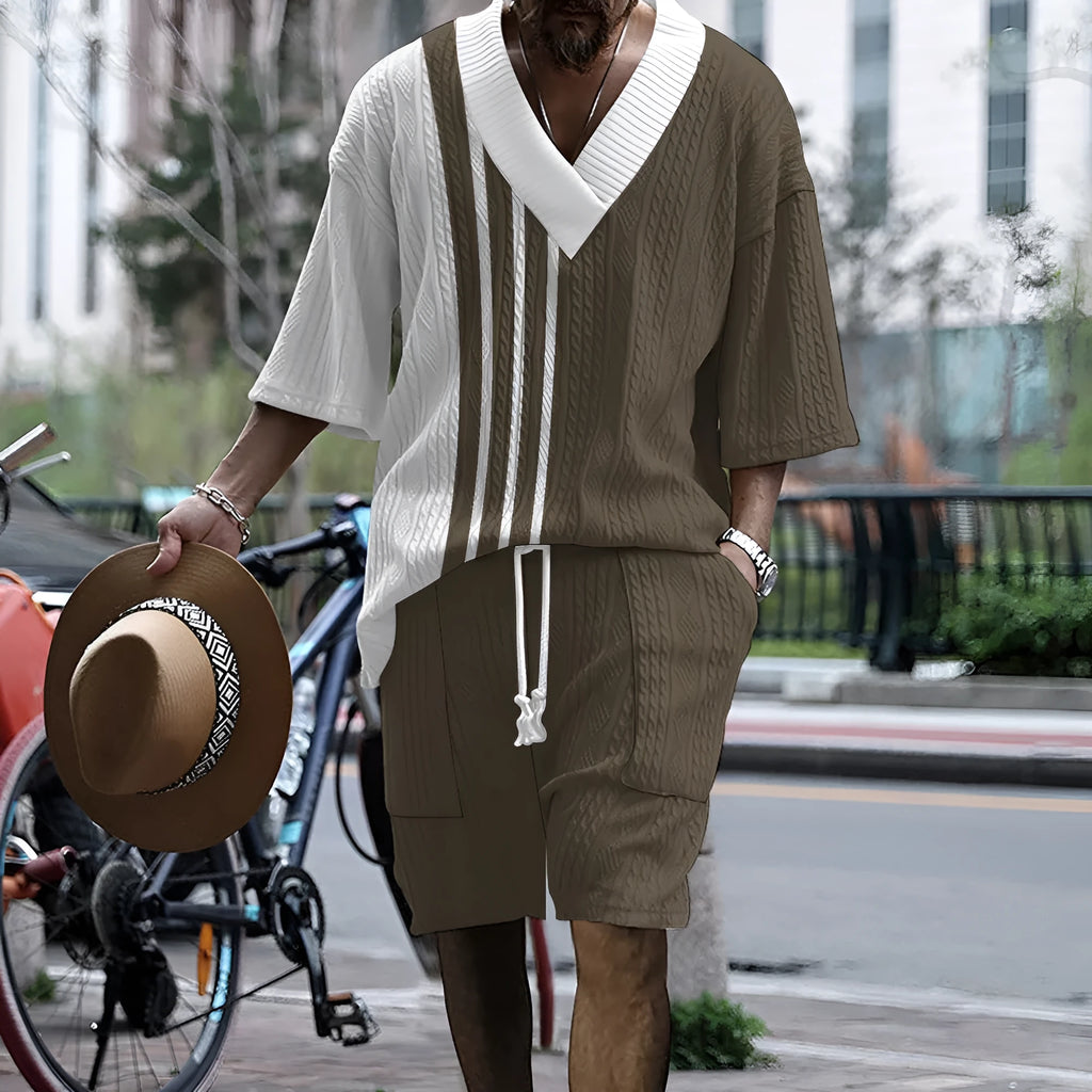 Man wearing a printed drop-shoulder knitted short-sleeve jacket with matching shorts in a casual setting.