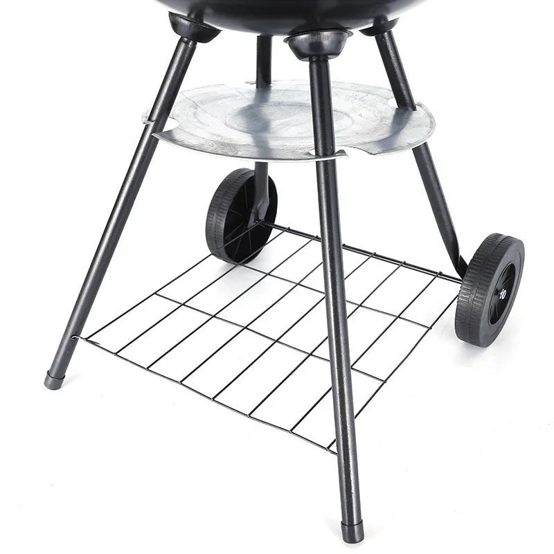 A portable cast iron barbecue oven with a 14-inch cooking surface, shown outdoors.