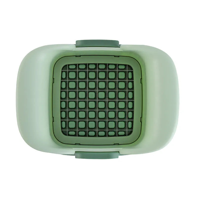 Green manual vegetable chopper with stainless steel cutting grid for slicing onions, potatoes, radishes and cucumbers