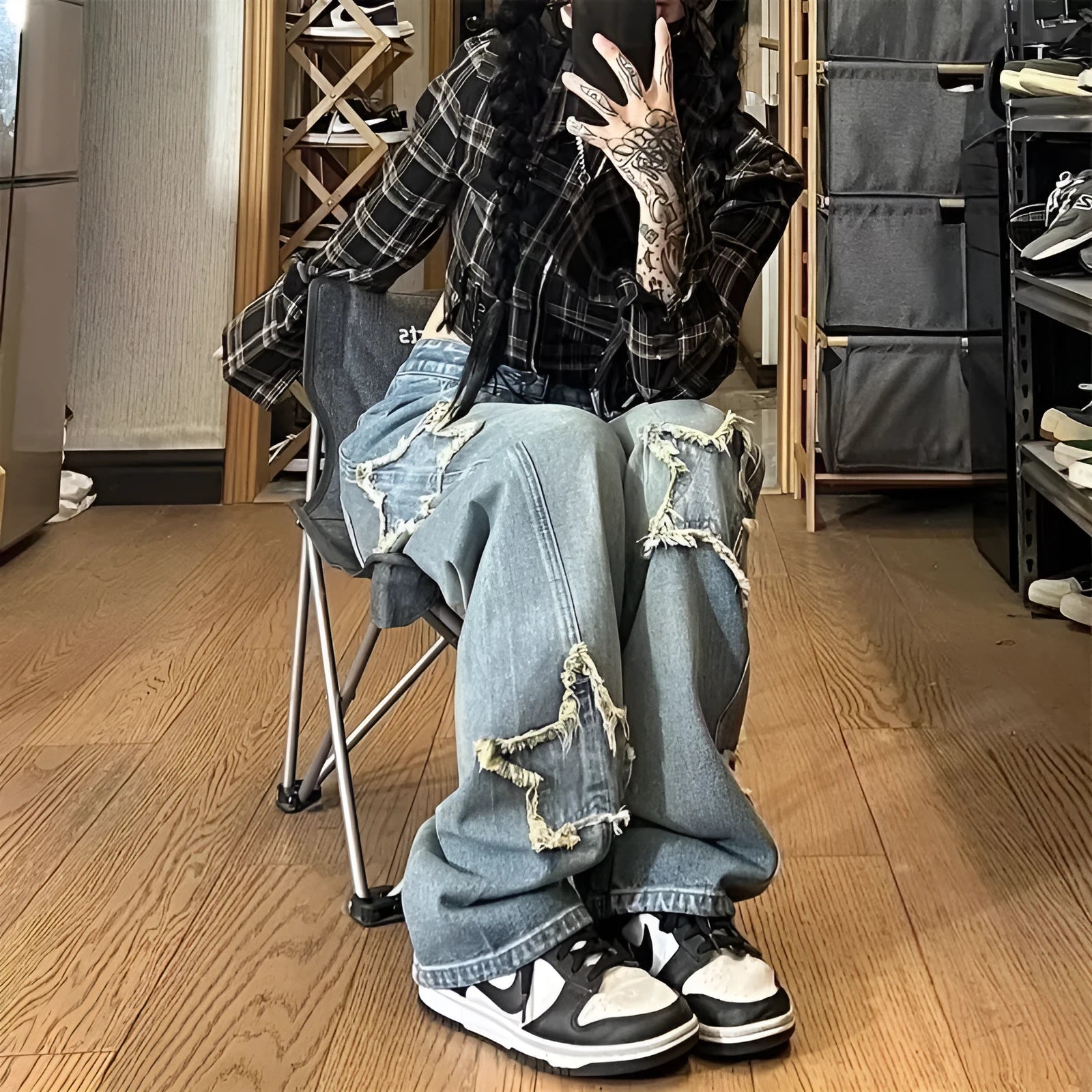 Blue high-waisted women's wide-leg denim jeans on a model, showing the straight-leg cut.