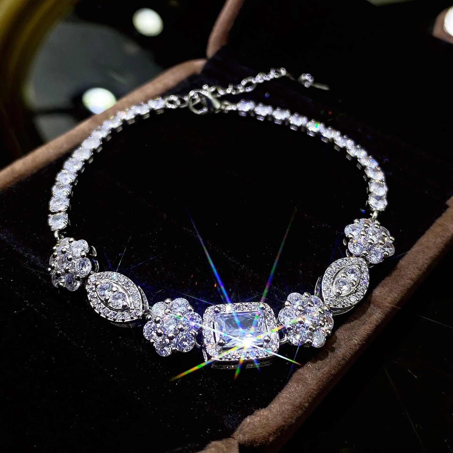Women's geometric zircon bracelet with silver and white gold plating showing chain length options