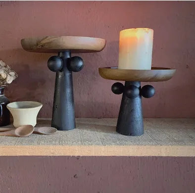 High-legged round wooden tray in a modern Nordic style for candle and decor display.