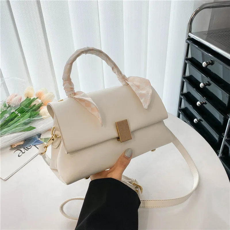 Medium-hardness PU shoulder handbag in horizontal square shape with visible sewing thread detail, black colour option