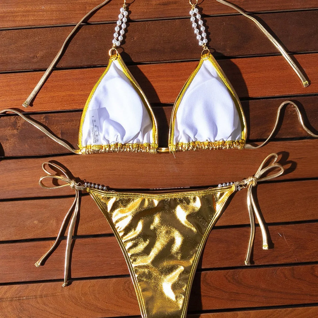 Gold halter lace-up bikini swimsuit with pearl chain detailing on mannequin