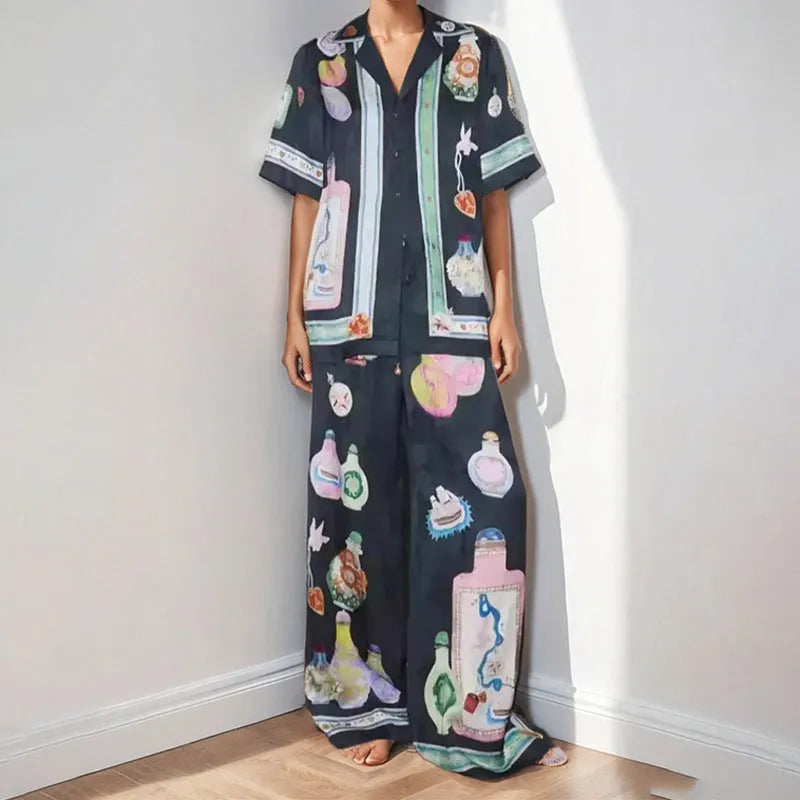 Black women's cardigan and trousers set with cartoon animation print, shown as a two-piece outfit.