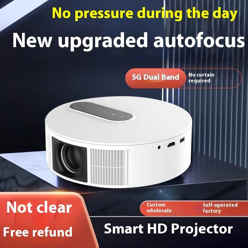 White smart HD home theatre projector with remote control on a wooden table.
