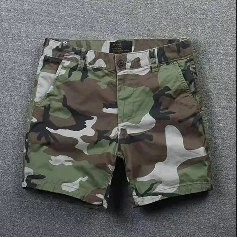 Men's cotton loose shorts in straight-leg cut with zipper fly, shown in multiple colour options including camouflage patterns