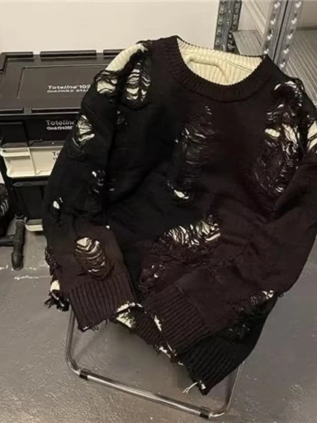 Men's black ripped sweater with animal pattern and tassels on front