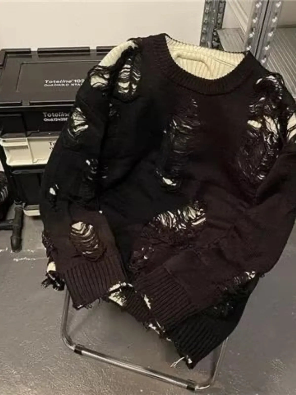 Men's black ripped sweater with animal pattern and tassels on front