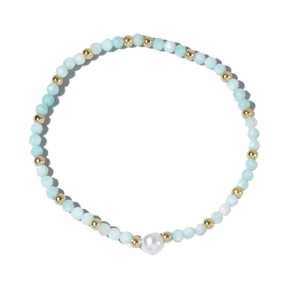 Close-up of a unisex natural stone bracelet with geometric ellipse beads on a wrist.