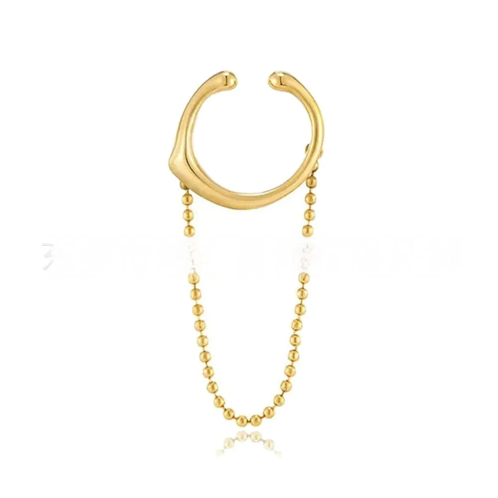 Ball chain tassel ear clip in gold on left ear, copper geometric U-shaped design