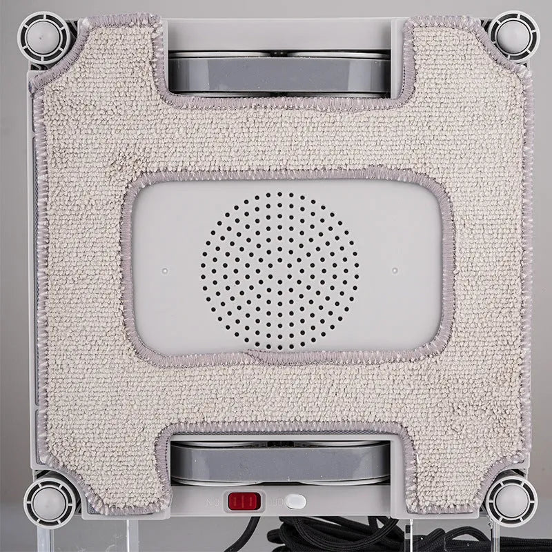 White intelligent window cleaning robot on a glass window, dimensions 220mm by 220mm by 70mm.