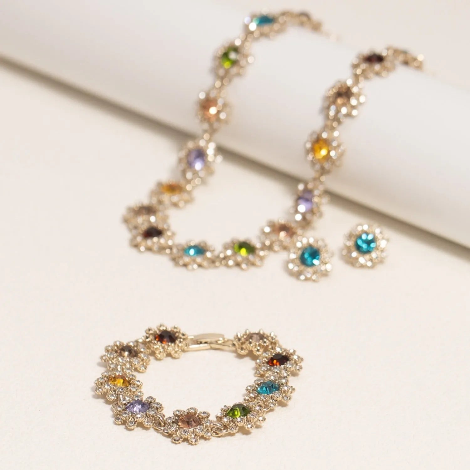 Colorful rhinestone necklace, earrings, and bracelet set on display, electroplated zinc alloy, geometric pendant