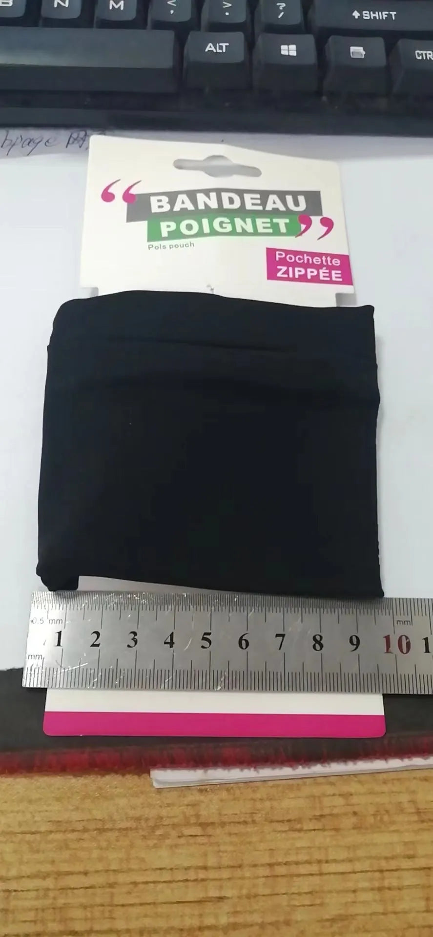 Compact black wrist armband bag for mobile phone, shown with dimensions 10cm by 10.5cm.