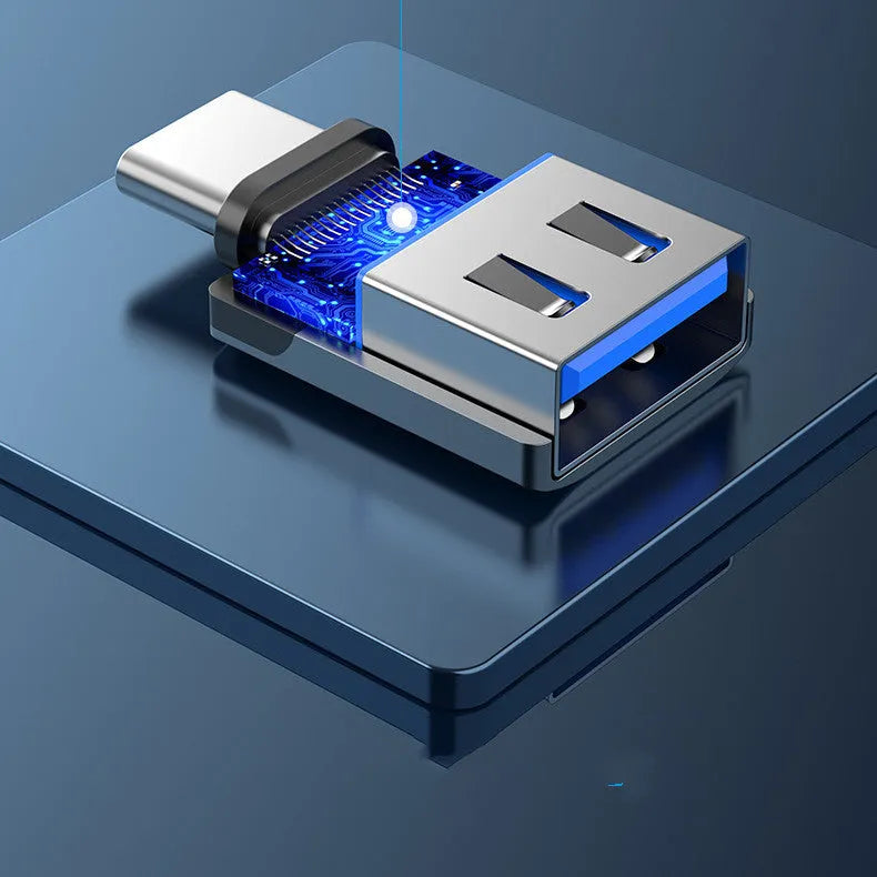 Grey aluminium USB 3.0 OTG adapter with USB-C male and USB-A female connectors and a lanyard.