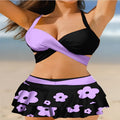 Women's black lace-up bikini top with matching high-waist swim skirt laid flat.