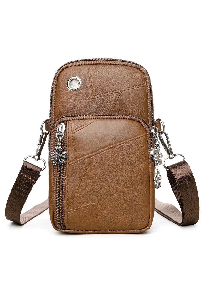 Square vertical mini mobile phone bag in PU leather, shown in water blue colour with a front sandwich pocket.