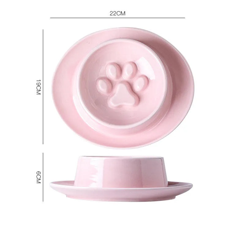Green ceramic slow feed pet bowl with internal ridges and a raised centre on a white surface.