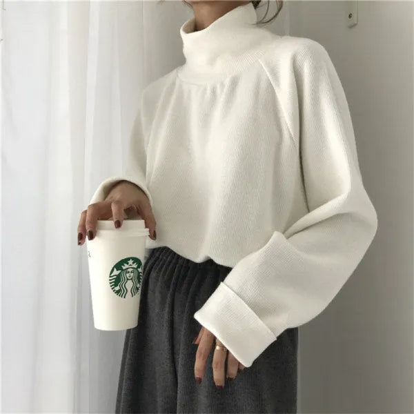Women's loose fit long sleeve polyester top with half-high collar in solid apricot colour
