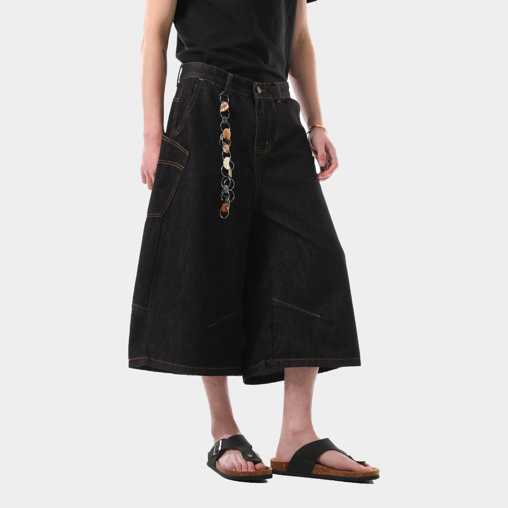 Man wearing black retro washed straight-leg denim cropped pants with side pockets.