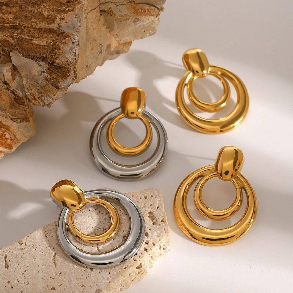 Round golden double layer hollow stud earrings for women with a geometric design.