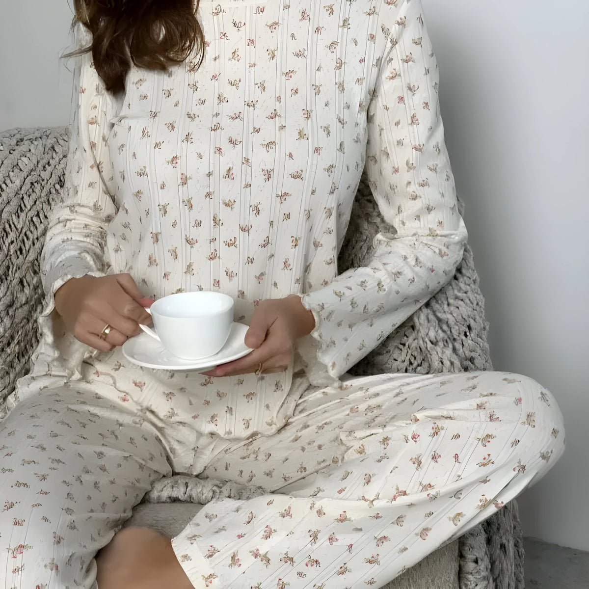 Women's white floral print bell sleeve round neck top and wide leg pants loungewear suit on model