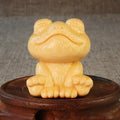 Solid bamboo carved ornament of a smiling cartoon frog, 5cm tall.