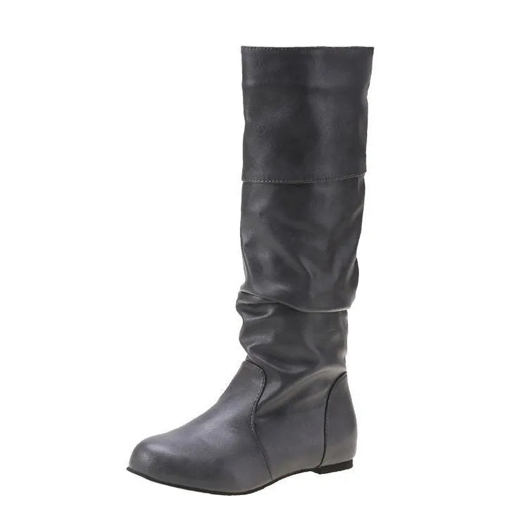 Women's black slip-on flat boots with a round toe and high cylinder shaft, showing the rubber sole.