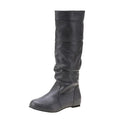 Women's black slip-on flat boots with a round toe and high cylinder shaft, showing the rubber sole.