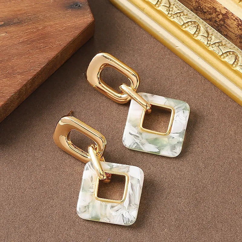 Hollow geometric square earrings with chamfered pattern in electroplated copper