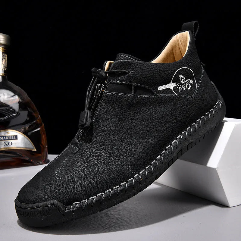 Casual men's leather travel shoes in black with rubber sole, mid heel, and round toe