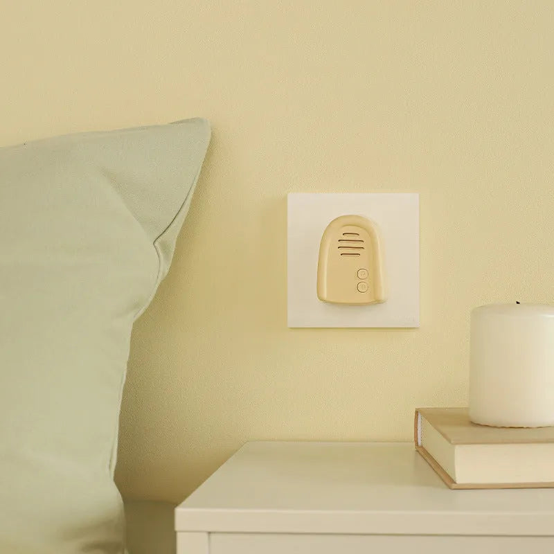 Wireless plug-in doorbell with self-generating chime in milky yellow or white colour options