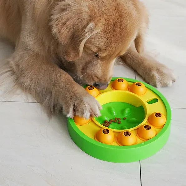 Square blue interactive dog puzzle bowl with a central feeding column and a turntable lid on a wooden floor.