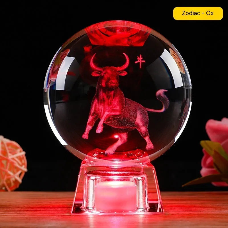 White crystal ball zodiac ornament with luminous electronic base showing Chinese animal designs