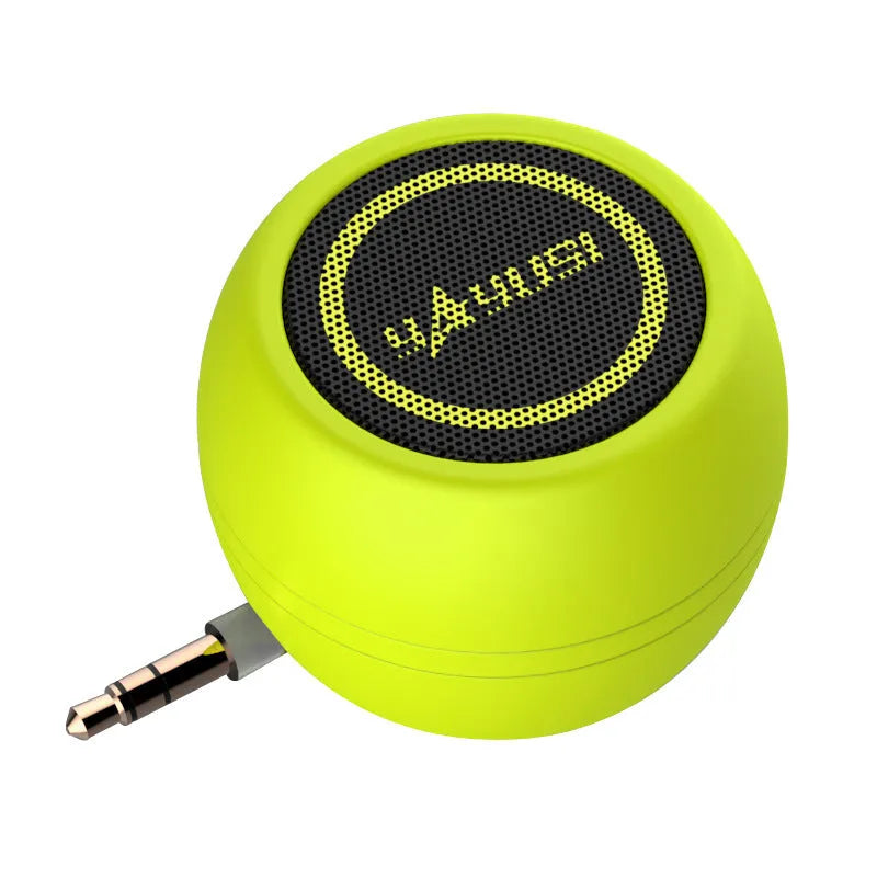 A5 portable mini speaker in red with 3.5mm audio plug and ABS plastic casing on a table