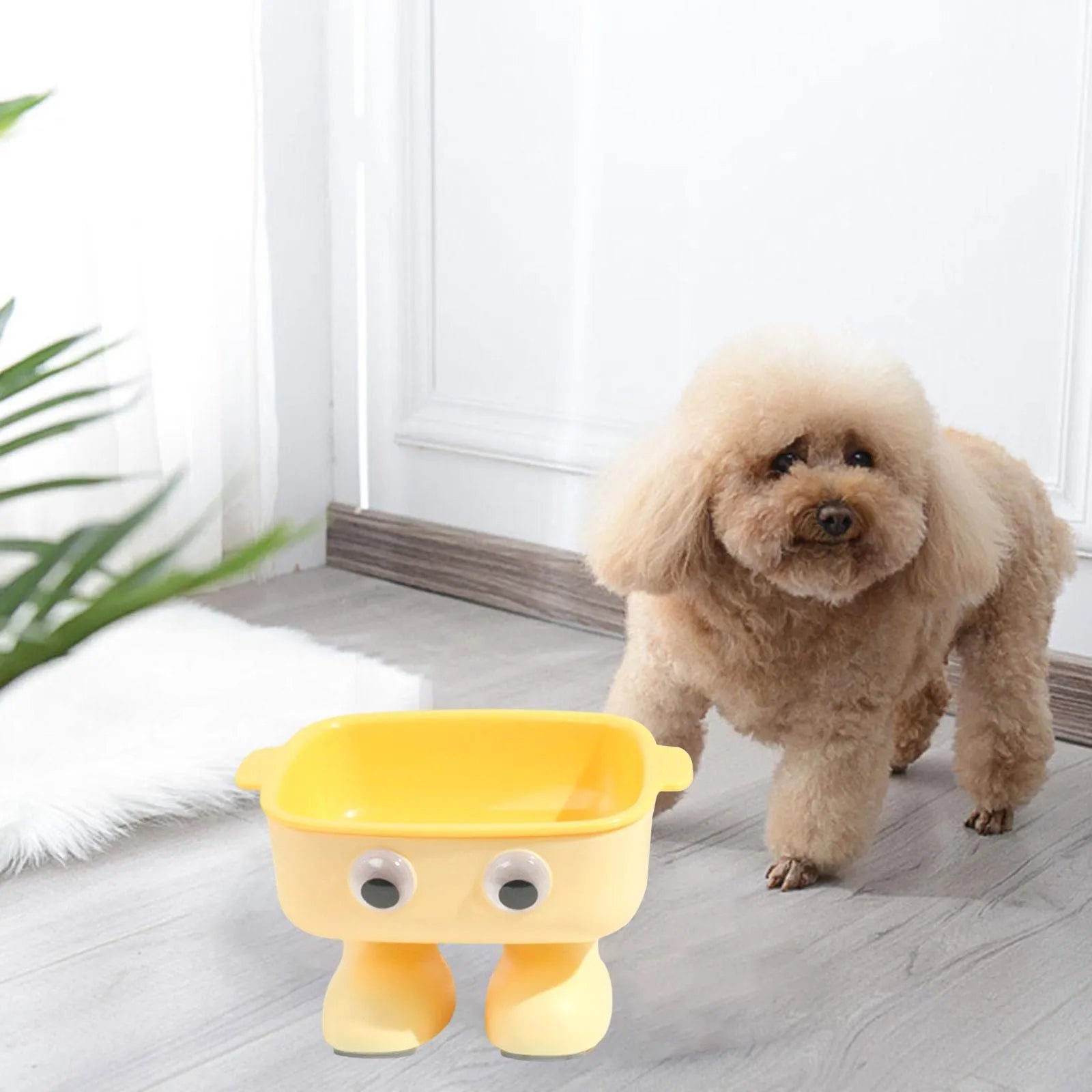 Green robot-shaped elevated cat bowl with tilted design and removable inner bowl on anti-slip base