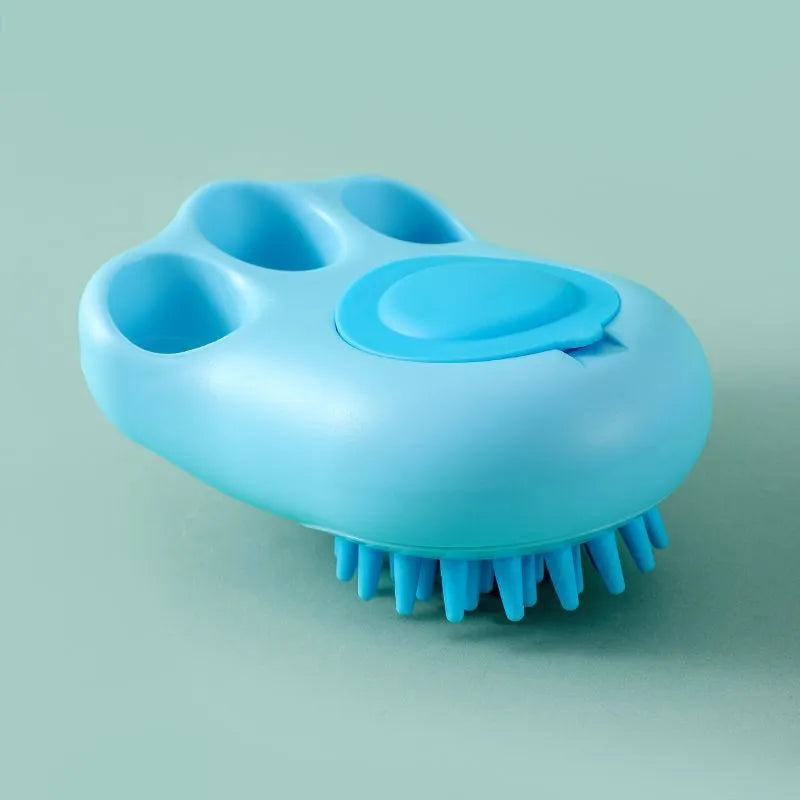 Blue pet bath and massage brush with silicone bristles and an ergonomic non-slip handle.