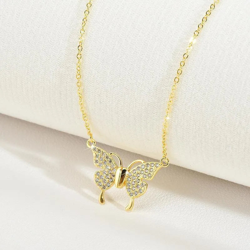 Gold titanium steel women's necklace with magnetic butterfly clasp and twisted chain.