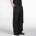 Black single pleated straight-leg trousers with an adjustable waistband on a hanger.
