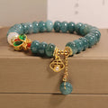 Blue water jade abacus bead and white agate bracelet with alloy and rhinestone details for women.