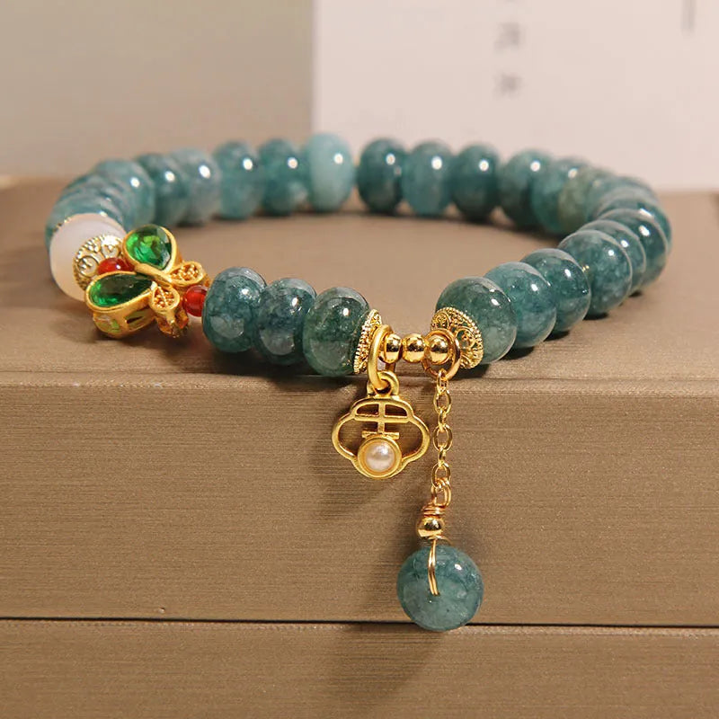 Blue water jade abacus bead and white agate bracelet with alloy and rhinestone details for women.
